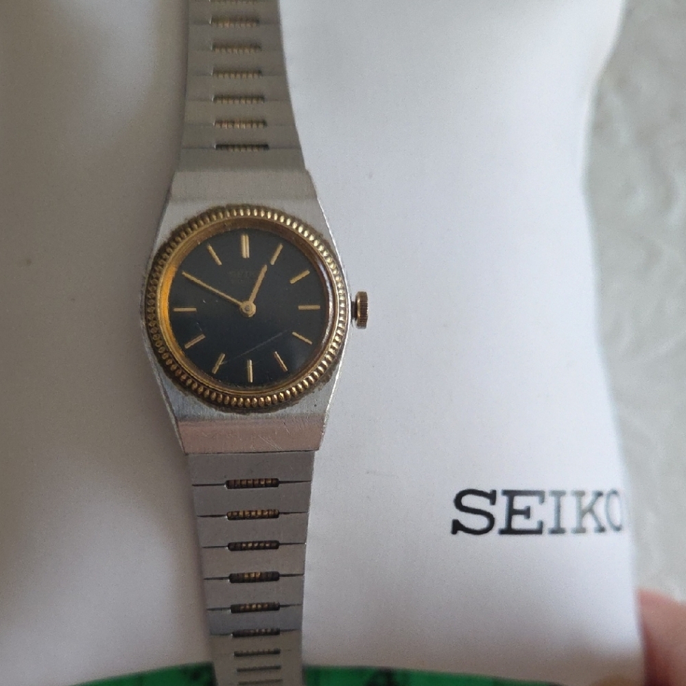 Seiko Small Two Tone Stainless Steel Band. Black Face. Gold Accents